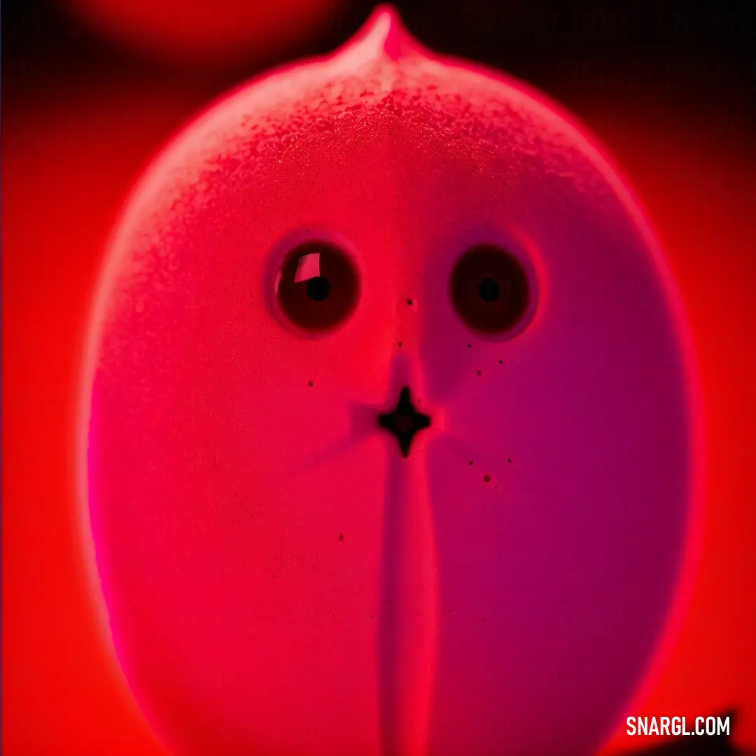 Close up of a pink object with eyes and a nose with a star on it's nose