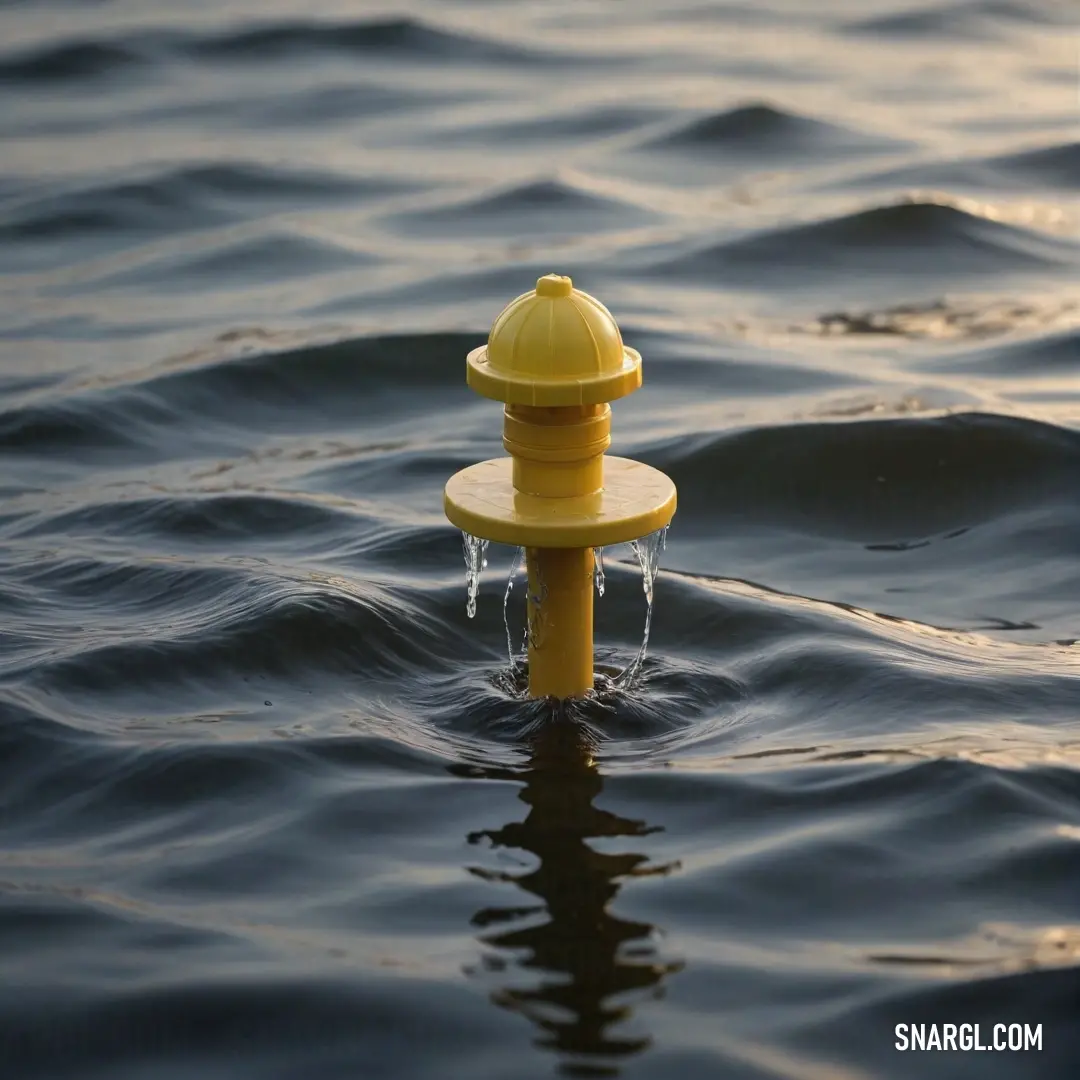 A vibrant yellow fire hydrant floats gently near the water's edge, surrounded by rippling waves. Its bright color contrasts beautifully with the calm surroundings, serving as a beacon of safety against the backdrop of nature's serenity.