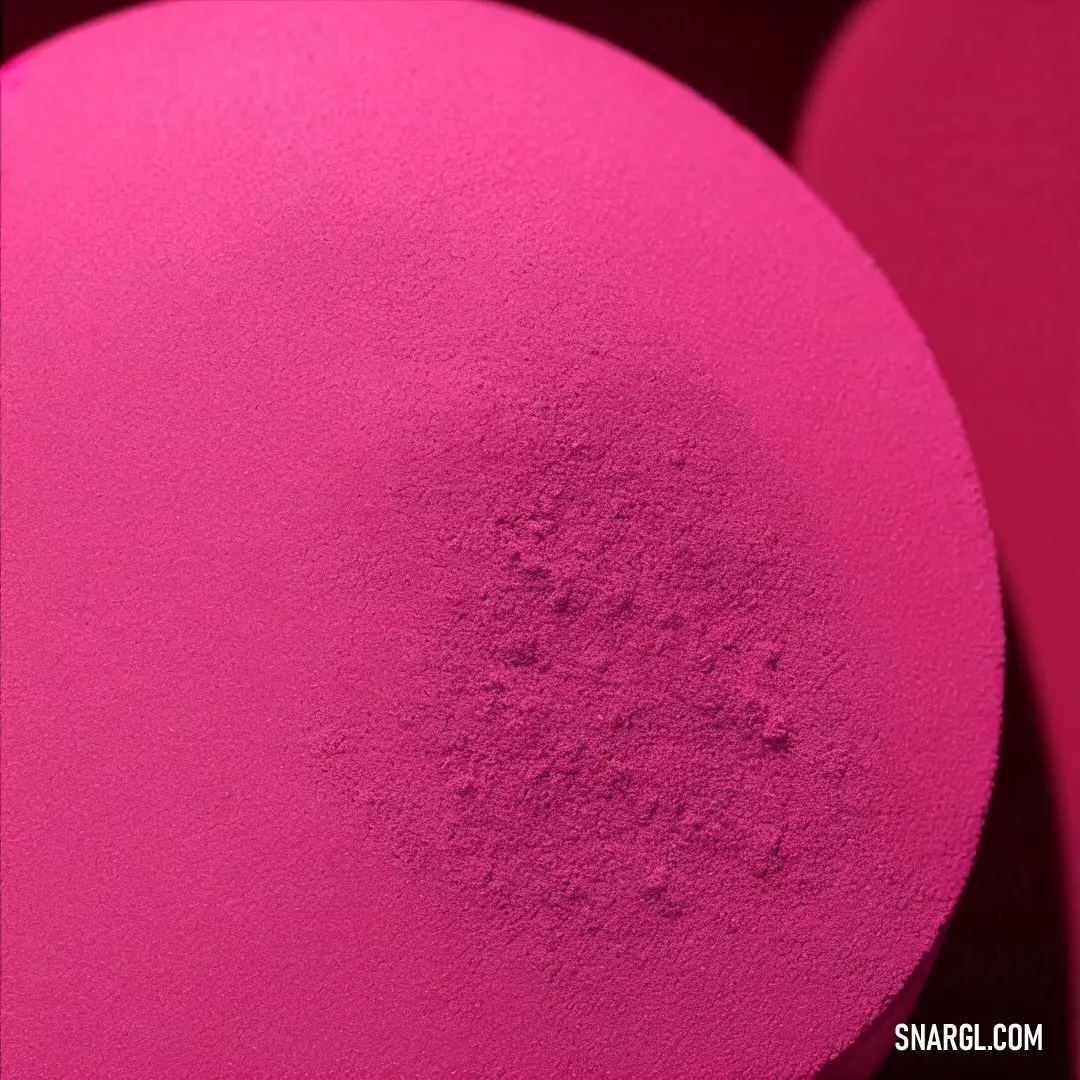 Pink object with a black background and a red circle in the middle of it