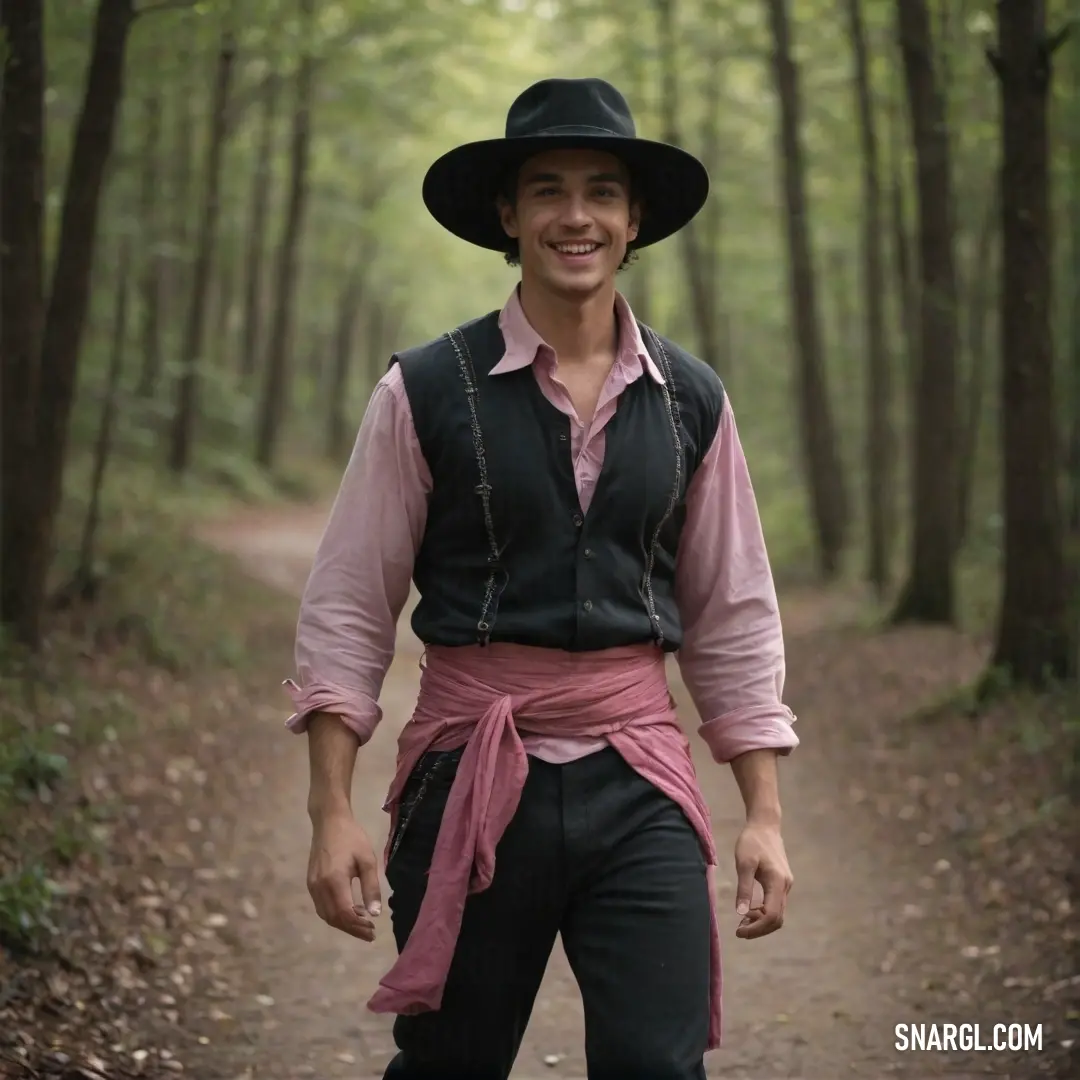 Man in a hat and vest is walking down a path in the woods wearing a black hat