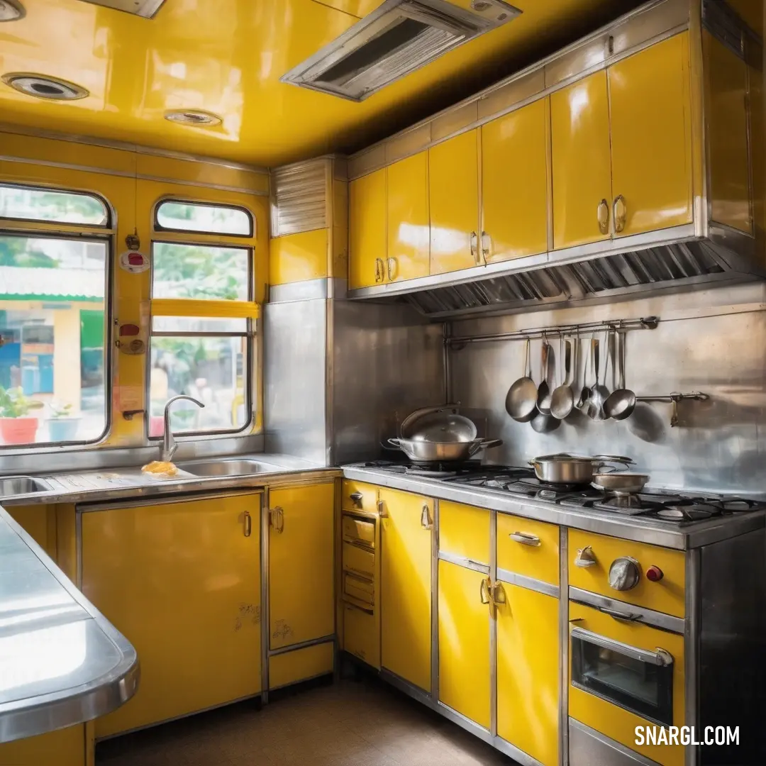 Kitchen with yellow cabinets and a window with a view of the street outside of it. Color Gold.