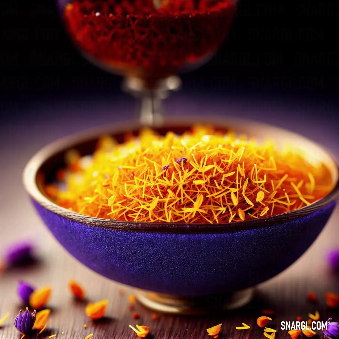Bowl of dried flowers on a table next to a wine glass and a spoon