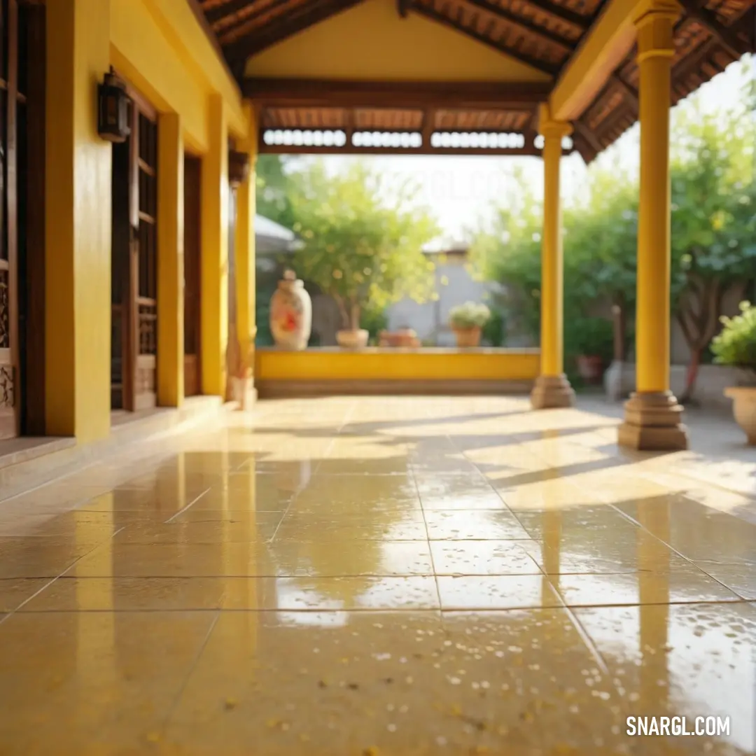 A stunning yellow building with a tiled floor, featuring a matching yellow wall and ceiling. A vase sits elegantly to the side, complementing the warm golden tones and creating a cozy, inviting atmosphere.