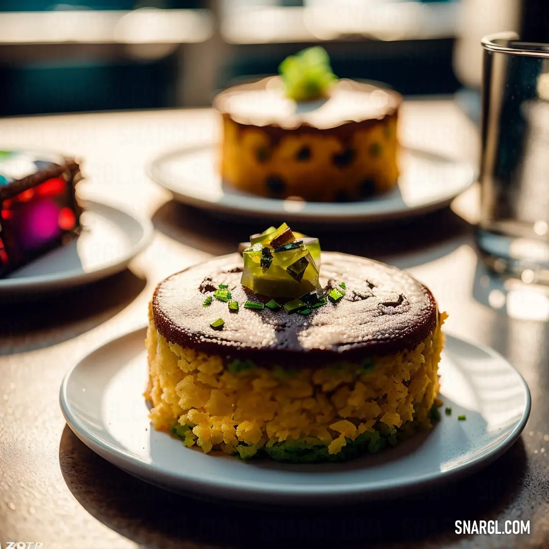 Table with three cakes on it and a glass of water on the table next to it. Color Goldenrod.