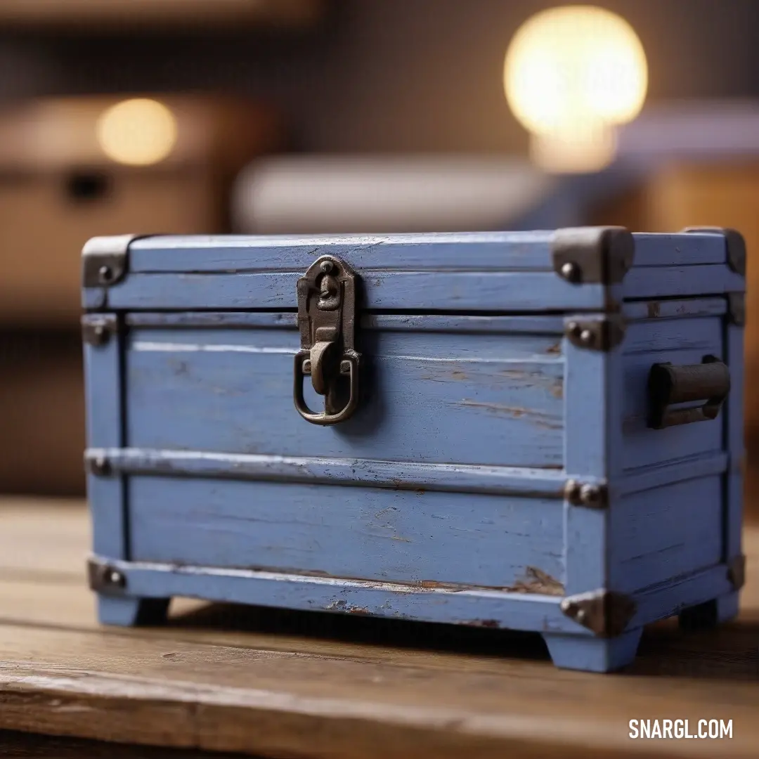 A delicate blue box sits atop a rustic wooden table alongside a softly glowing lamp and a subtly styled chair in the background. This serene setting embodies warmth and comfort, inviting viewers to bask in the cozy atmosphere.