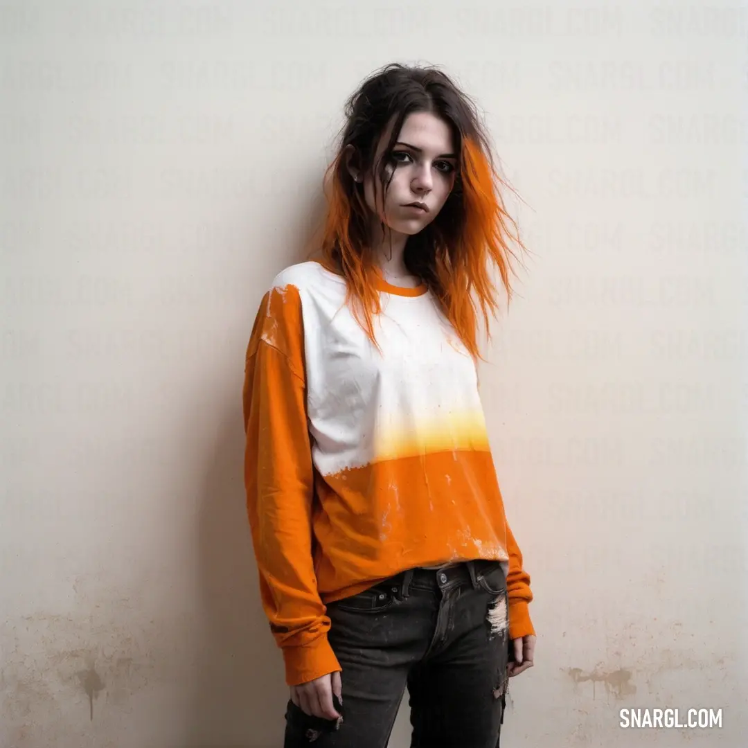 Woman with orange hair standing in front of a wall with a white shirt on and a black purse