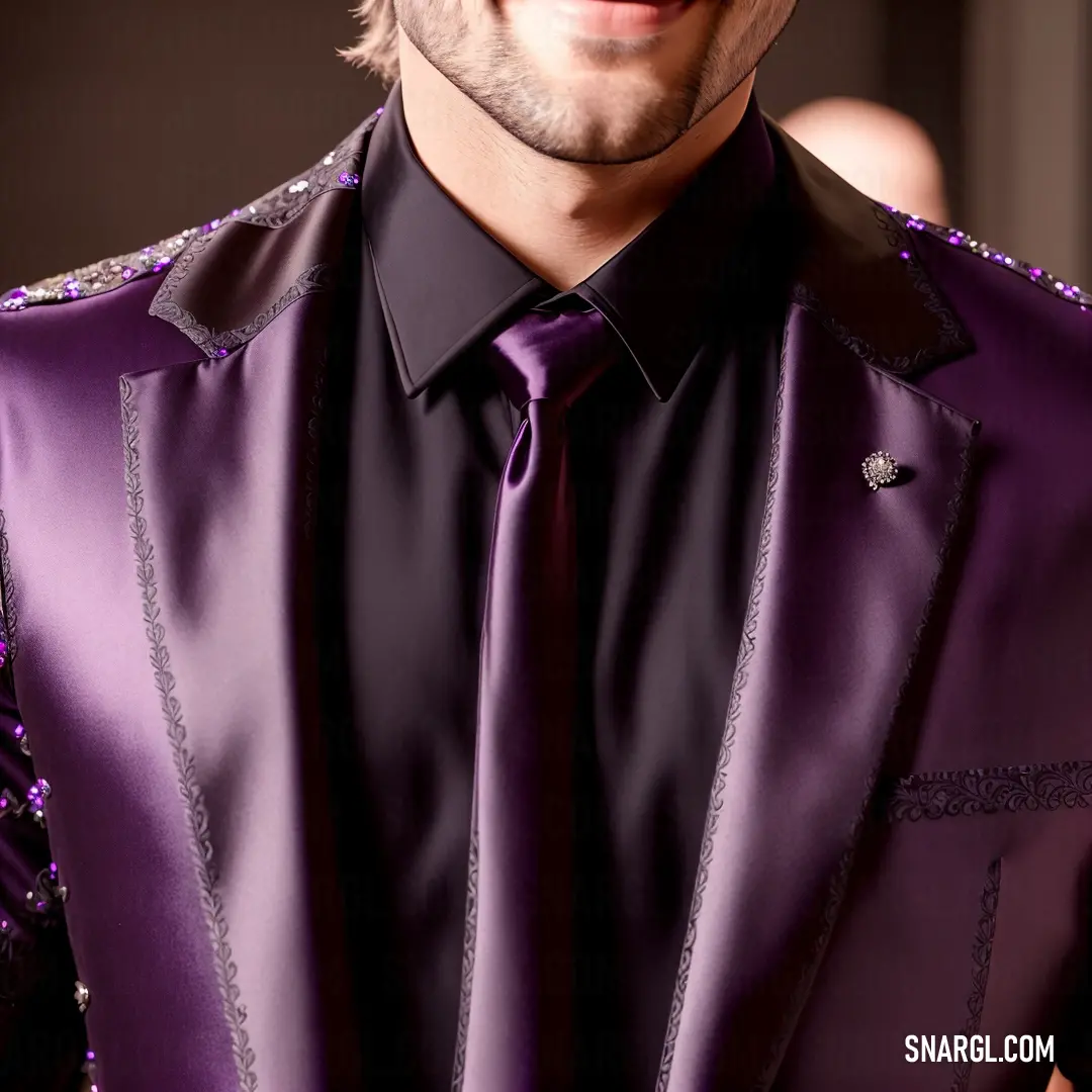 Man wearing a purple suit and tie with a black shirt and purple pants and a black shirt
