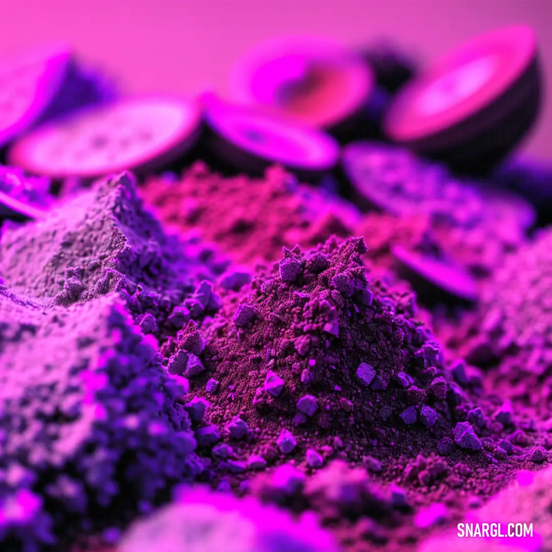 Pile of purple and pink colored powders on a table with other purple and pink colored powders