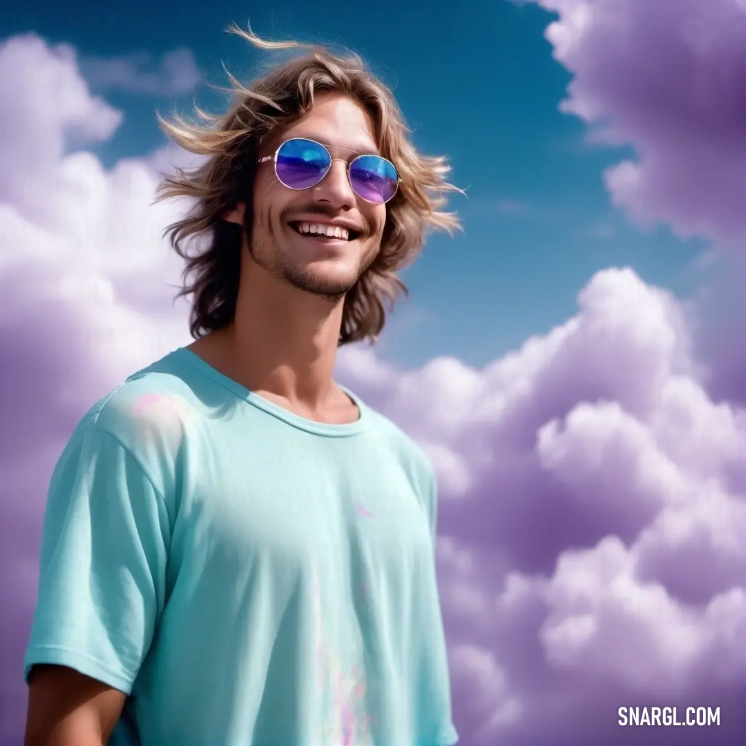 Man with long hair and sunglasses on a cloudy day with a blue sky and clouds behind him and a blue sky