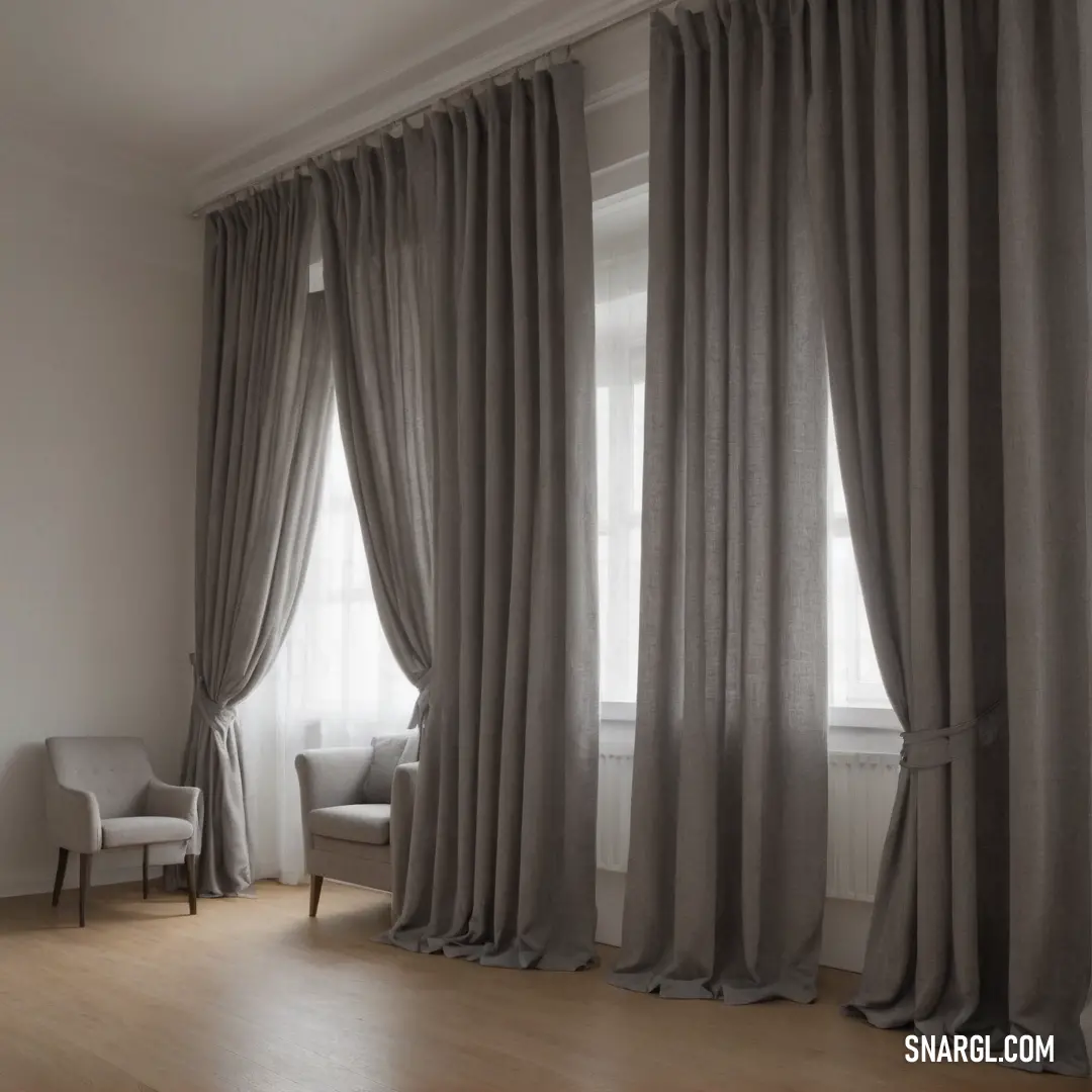 A serene interior showcases a cozy chair positioned near a large window, dressed in soft curtains that flutter with the wind, underlining the peaceful ambiance of the room with rosy wood floors.