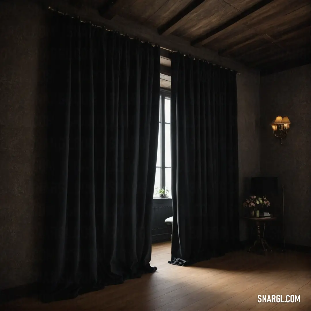 An elegant room with a grand window adorned with a sleek black curtain, paired with a stylish lamp casting a warm glow on the wooden flooring, creating a sophisticated atmosphere.