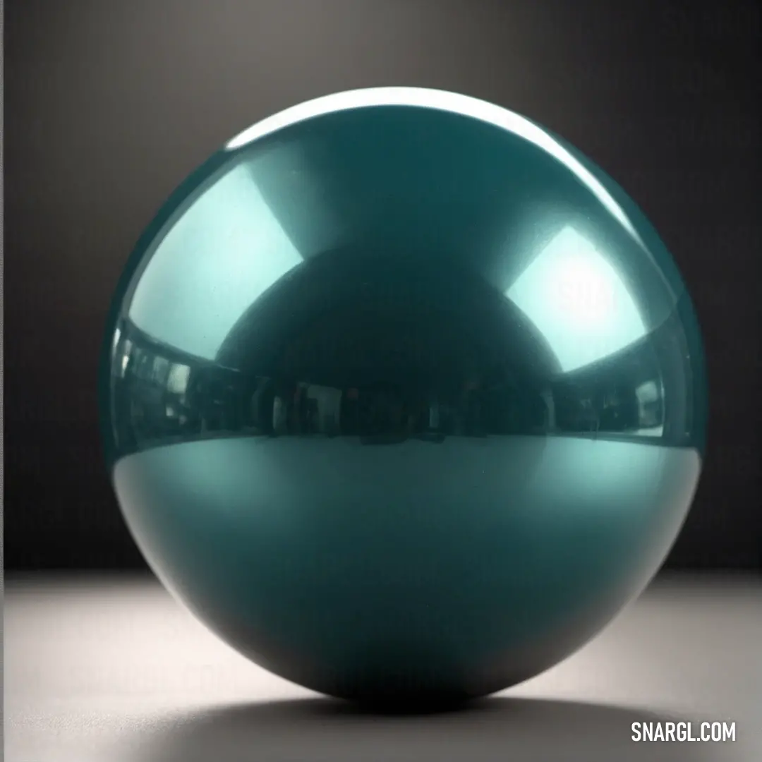 A shiny blue ball rests on a table against a stark black background. The reflective surface of the ball catches the light, creating a striking contrast with the deep, dark backdrop and the soft RGB 240,255,240 glow surrounding it.