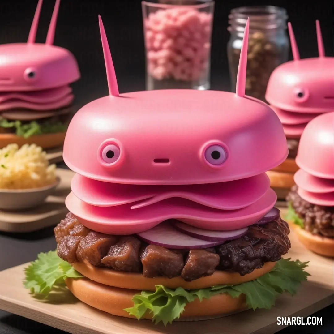 Hot pink color. Pink toy that looks like a hamburger with eyes and a face on it