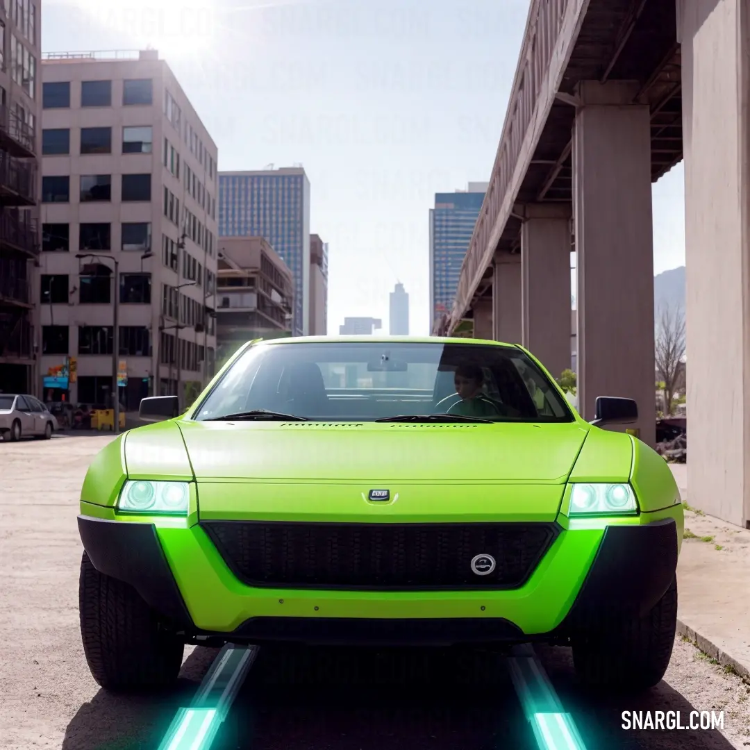Green car parked in a parking lot next to tall buildings and a bridge with a bright green light