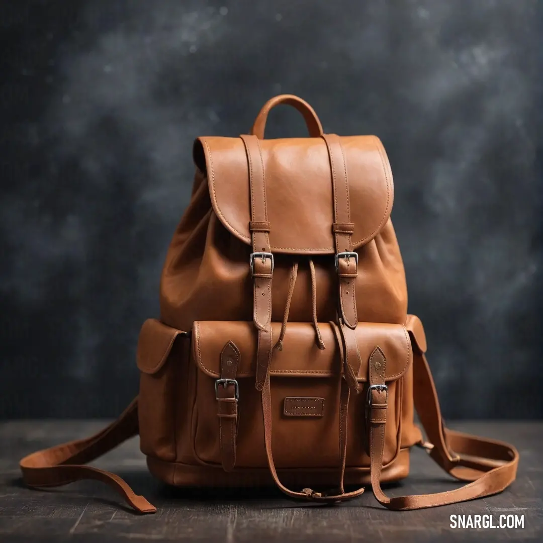 A stylish tan leather backpack rests elegantly on a rustic wooden table, set against a dramatic black background, showcasing its craftsmanship and design in a striking contrast.