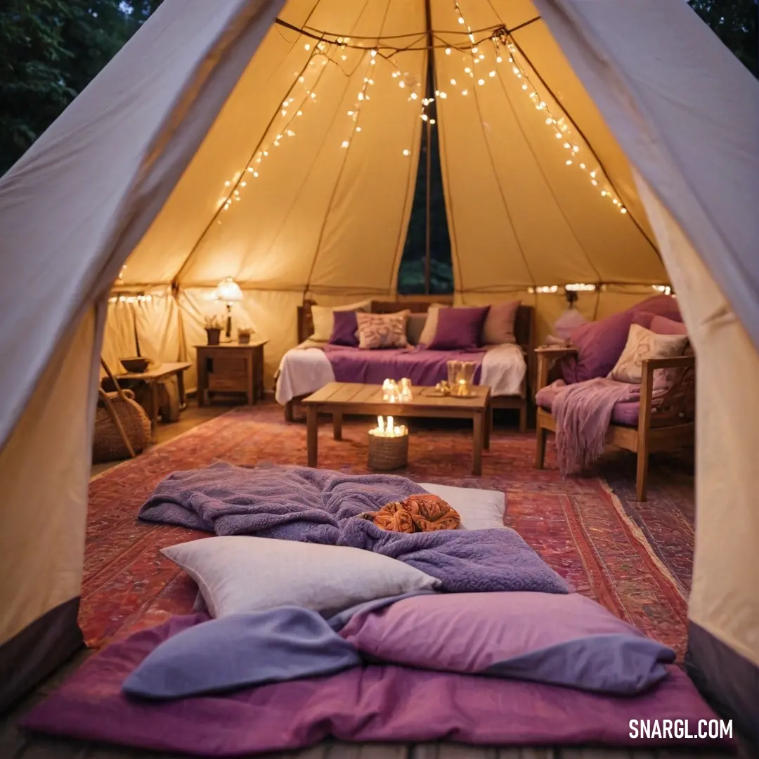 A delightful tent furnished with a comfortable couch, plush pillows, and a table adorned with a flickering candle, enveloping the space in a warm and inviting atmosphere perfect for relaxation and storytelling.