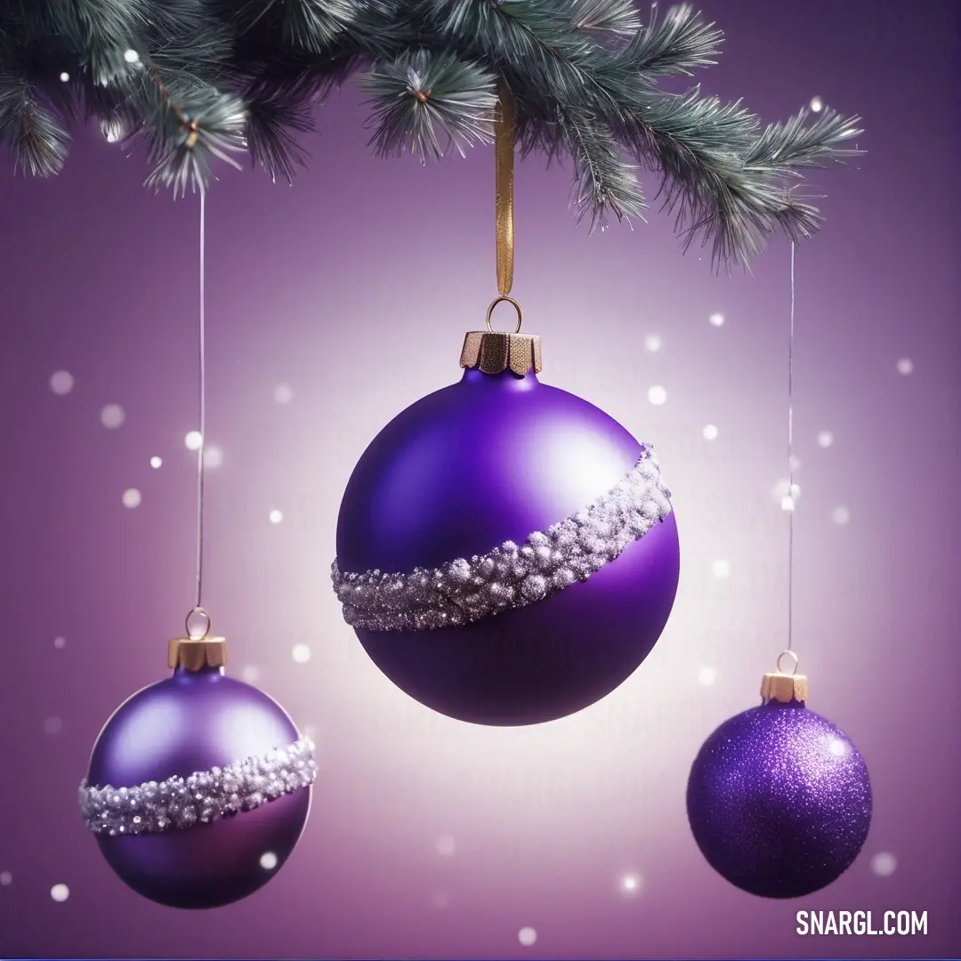 Three christmas ornaments hanging from a tree branch with snow flakes on it and a purple background. Example of RGB 75,0,130 color.