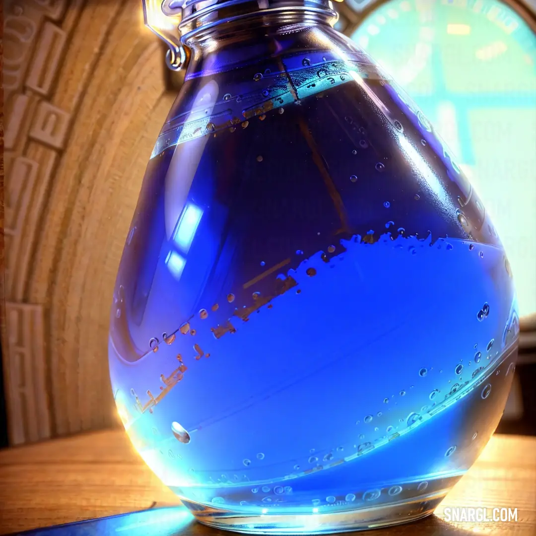 Iris color. Blue glass vase with water inside of it on a table next to a clock and a window with a wooden frame