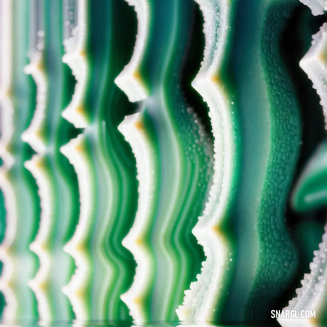 Close up of a green and white wall with wavy lines on it's sides