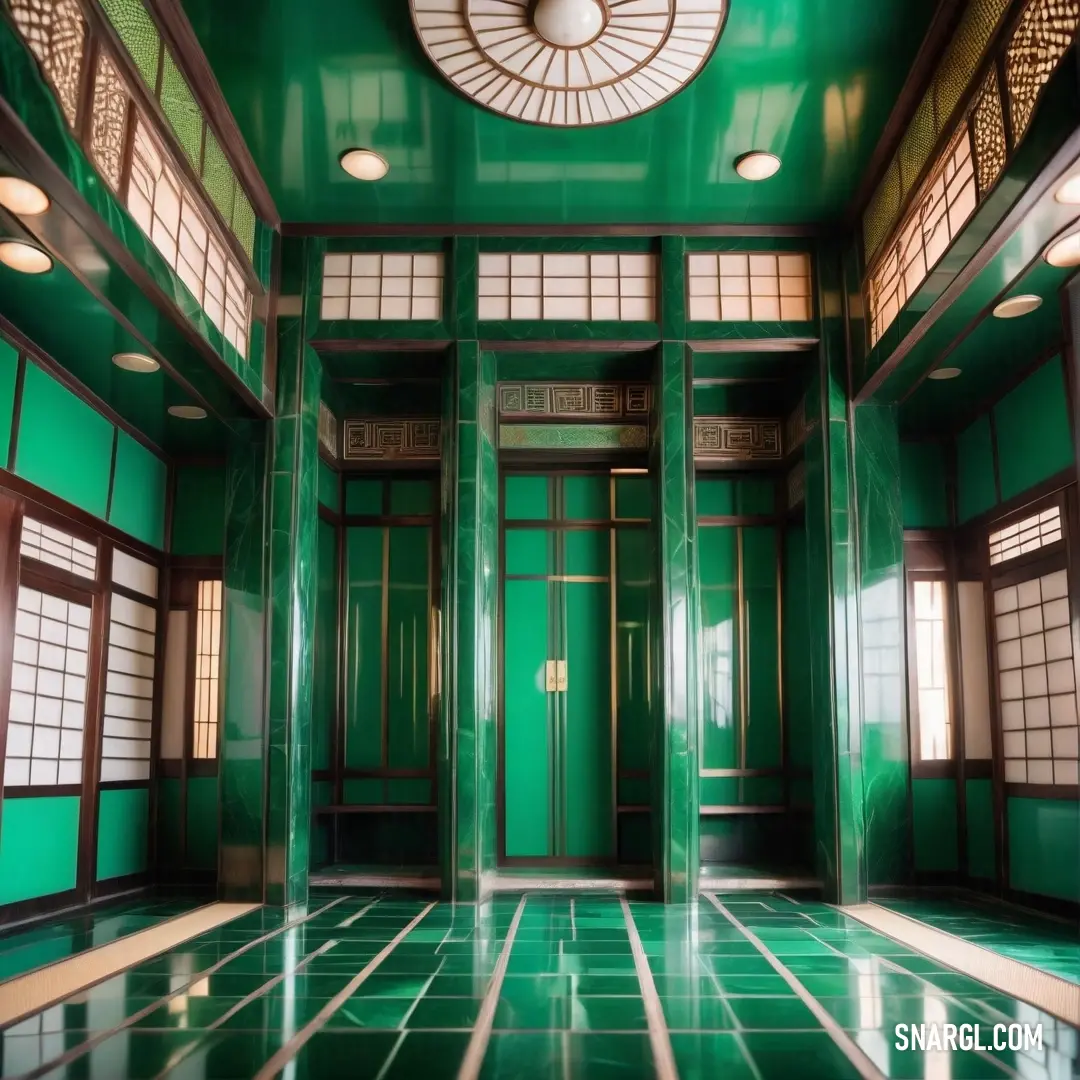 Room with green walls and a ceiling fan and a green door with windows and a round light fixture. Color Jade.