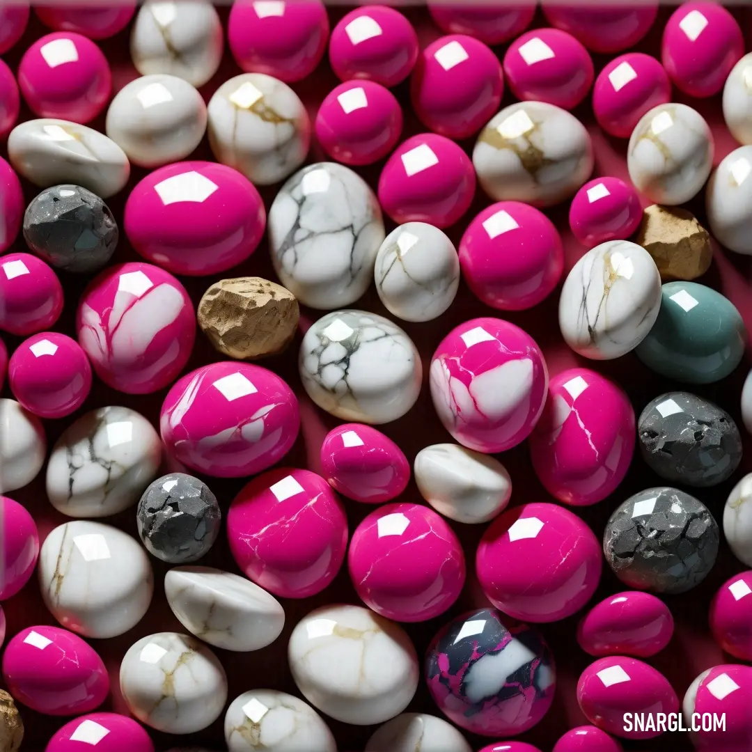 Close up of a bunch of candy with different colors of candy on it and a gold leaf on top. Color RGB 165,11,94.