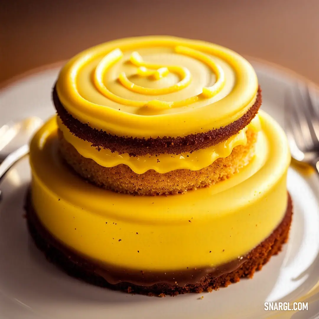 Three layer cake with yellow icing on a plate with a fork and knife next to it on a table