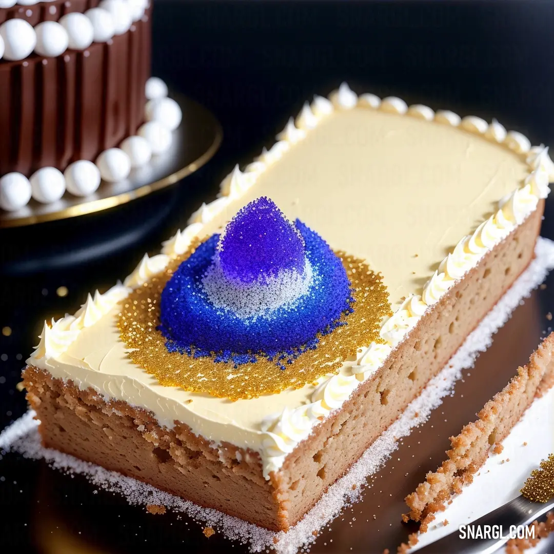 Piece of cake with a blue frosting on top of it on a plate with a knife and fork. Example of #002FA7 color.