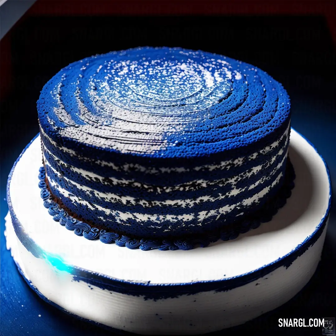 Klein Blue color example: Stack of blue and white cake on a white plate on a table with a red