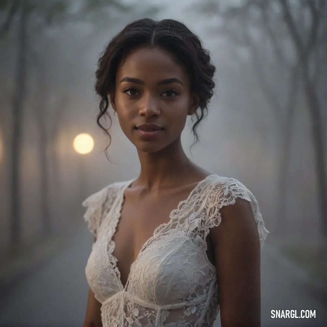 Woman in a white dress standing in the fog with trees in the background