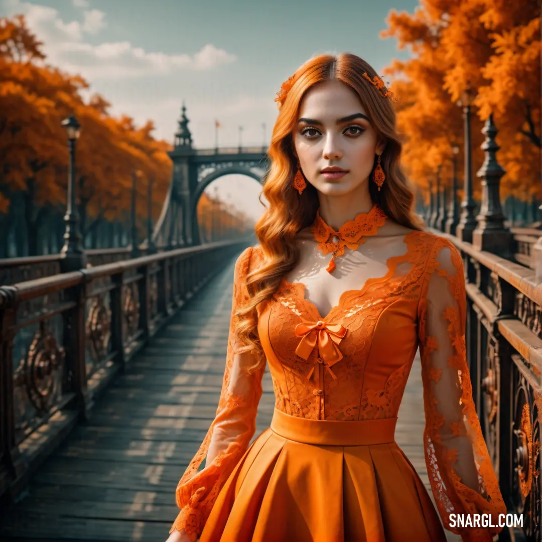 Woman in an orange dress standing on a bridge in a park with trees in the background