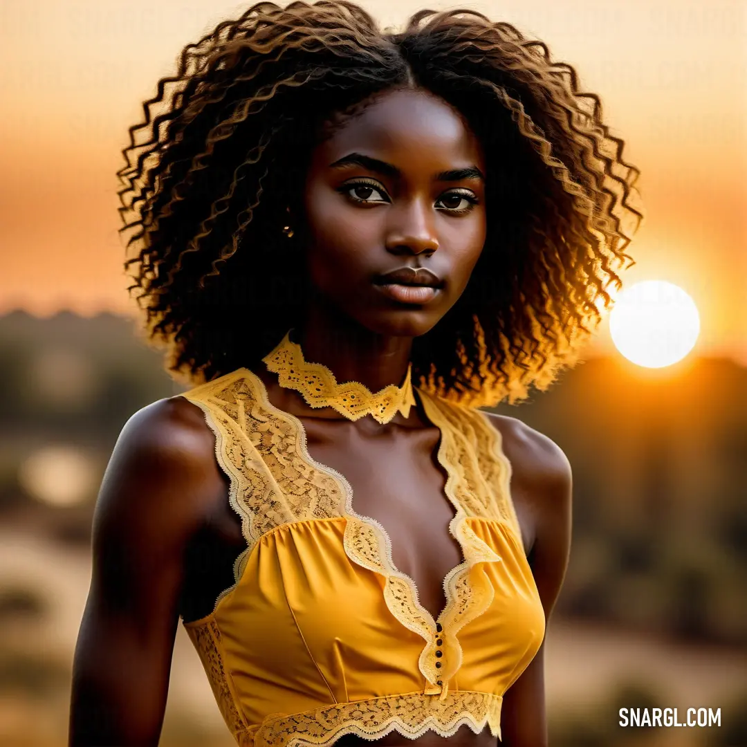 Woman with a yellow top and a yellow necklace on her neck and a sunset in the background