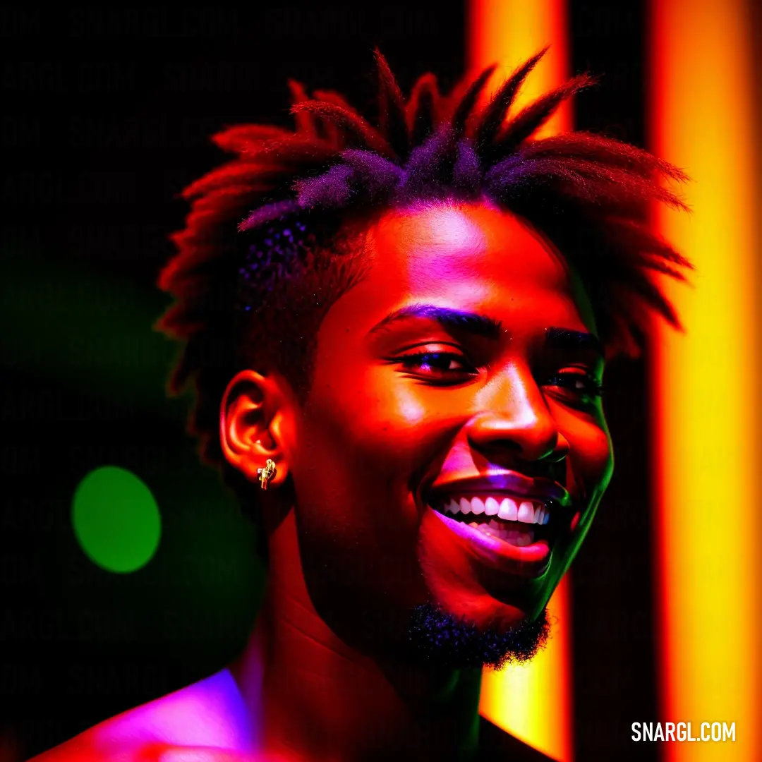 Man with dreadlocks smiling at the camera with a neon background behind him and a neon light behind him. Example of CMYK 0,92,85,19 color.