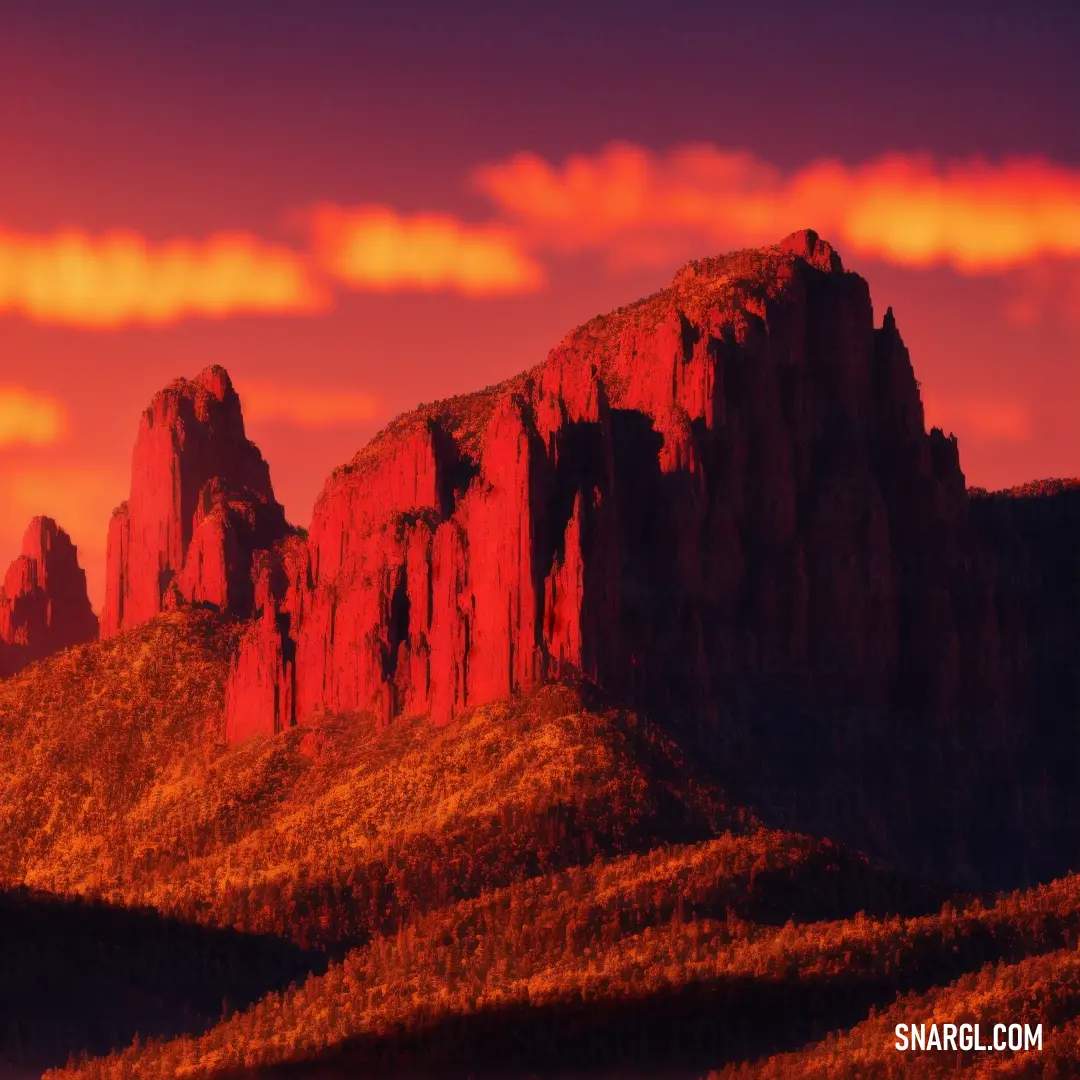 Mountain range with a red sky and clouds above it and a red sunset in the background