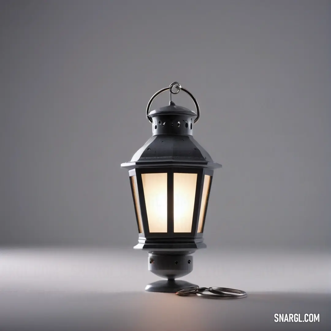 A black lantern with a soft white light sits on a surface, casting a warm glow against a lavender blush-colored backdrop.