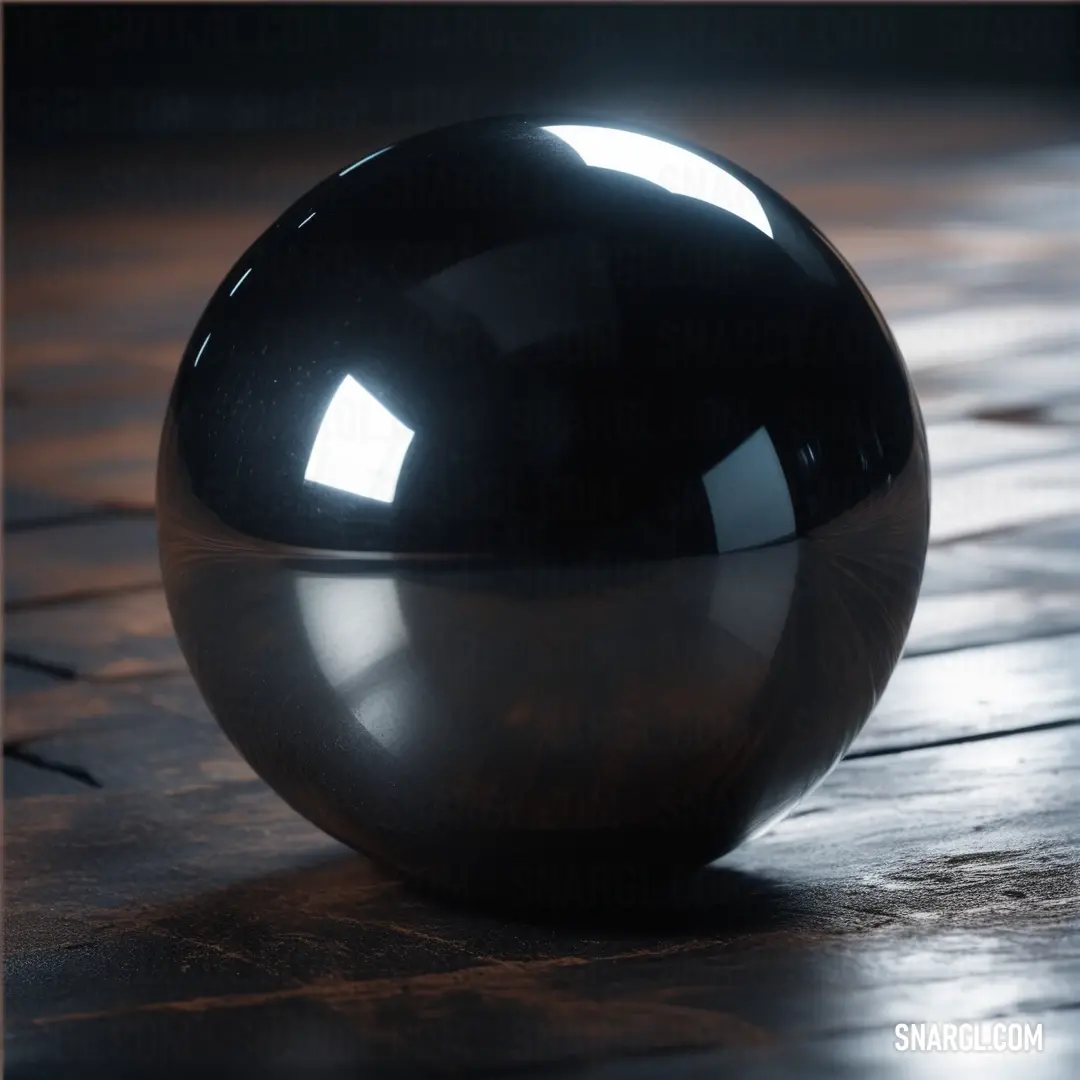 A shiny black ball rests on a wooden table, light pours through the top, illuminating the glossy surface as it creates dramatic reflections around the object. A striking example of dark elegance.