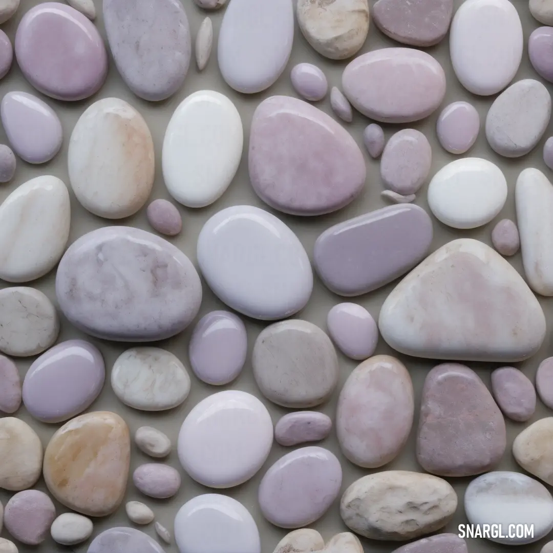 Close up of a rock wall with many different colors of rocks on it and a white background. Example of CMYK 6,6,0,18 color.