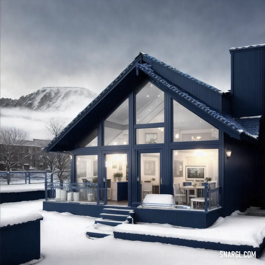 House with a snow covered roof and steps leading to it and a mountain in the background