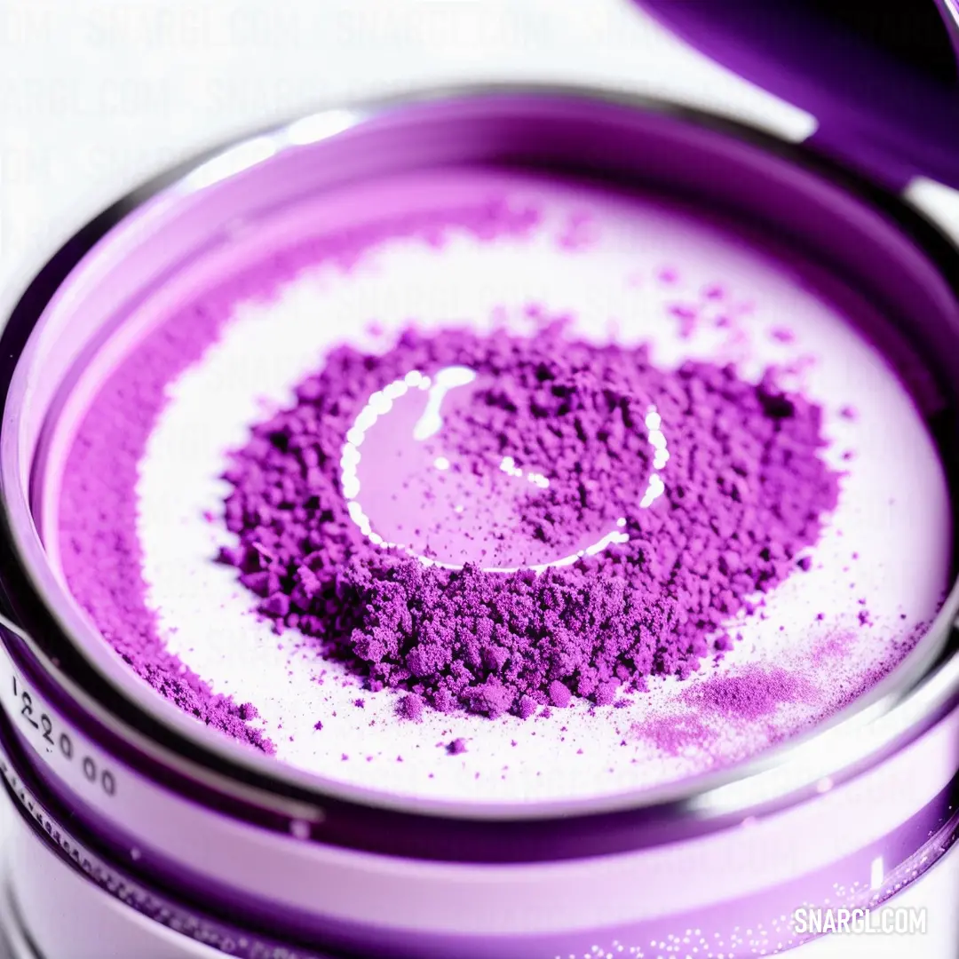 Purple powder in a glass container with a spoon in it and a white background with a purple circle