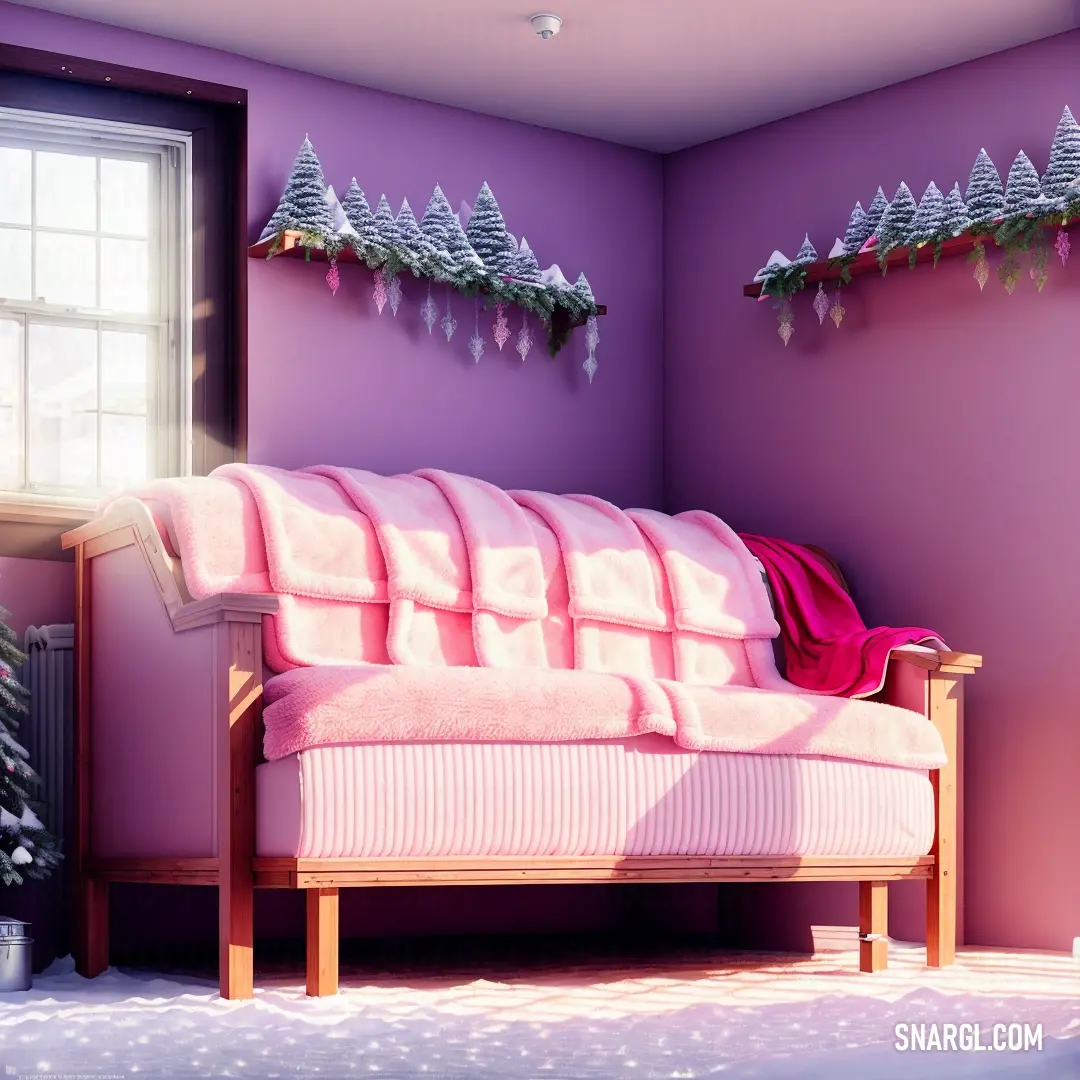 Pink couch in a room with a window and a christmas tree on the wall above it and a pink blanket on the back of the couch