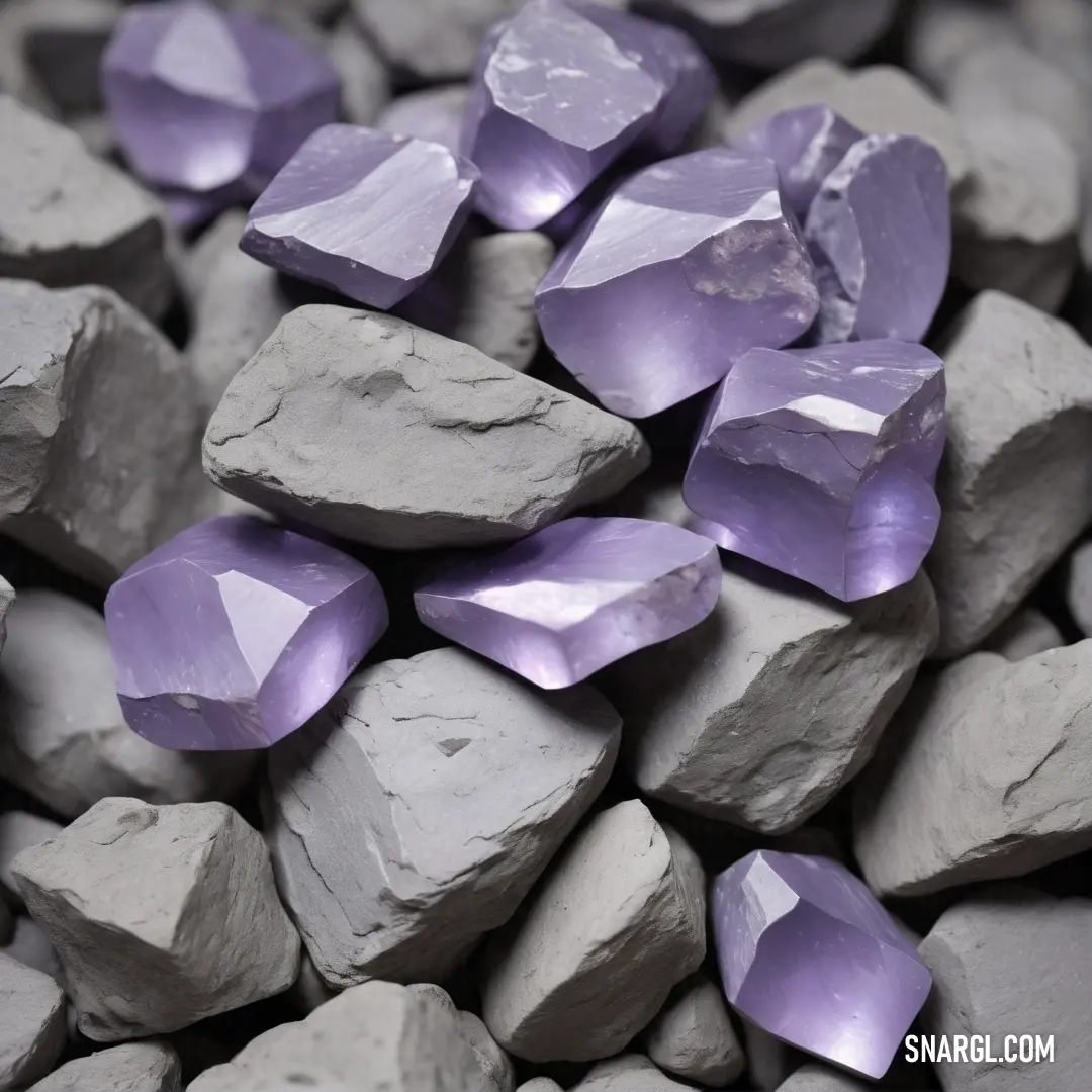 Pile of rocks with purple crystals on top of them and a black background. Example of RGB 230,230,250 color.