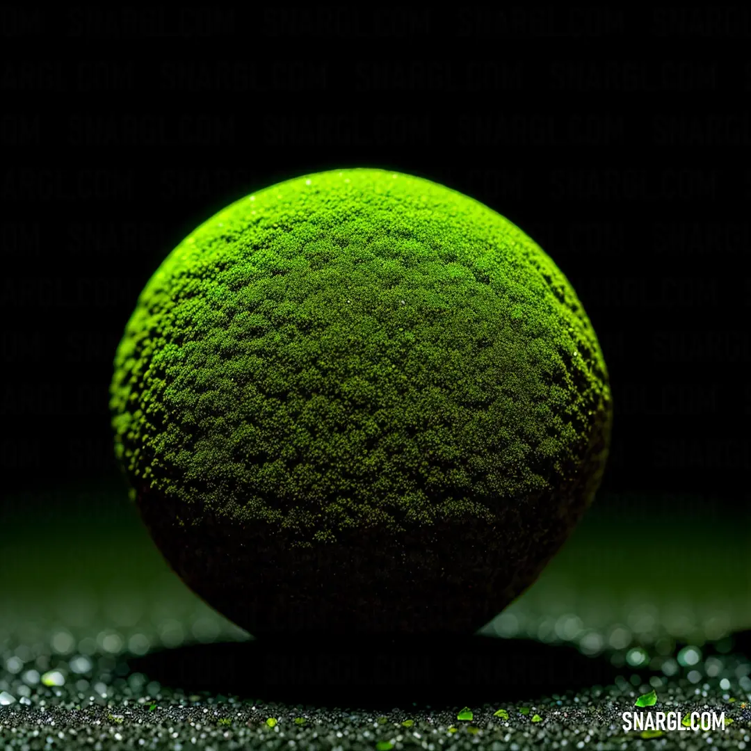 Green ball on top of a black surface with glitters on it. Example of RGB 191,255,0 color.