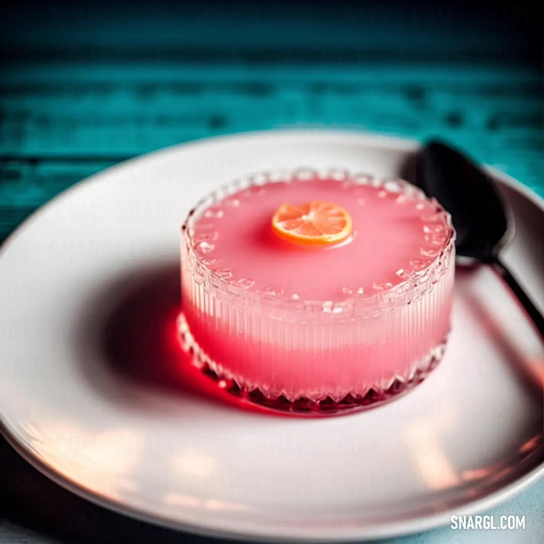 Small pink dessert on a white plate with a spoon and a blue table cloth behind it and a teal background. Color #E66771.