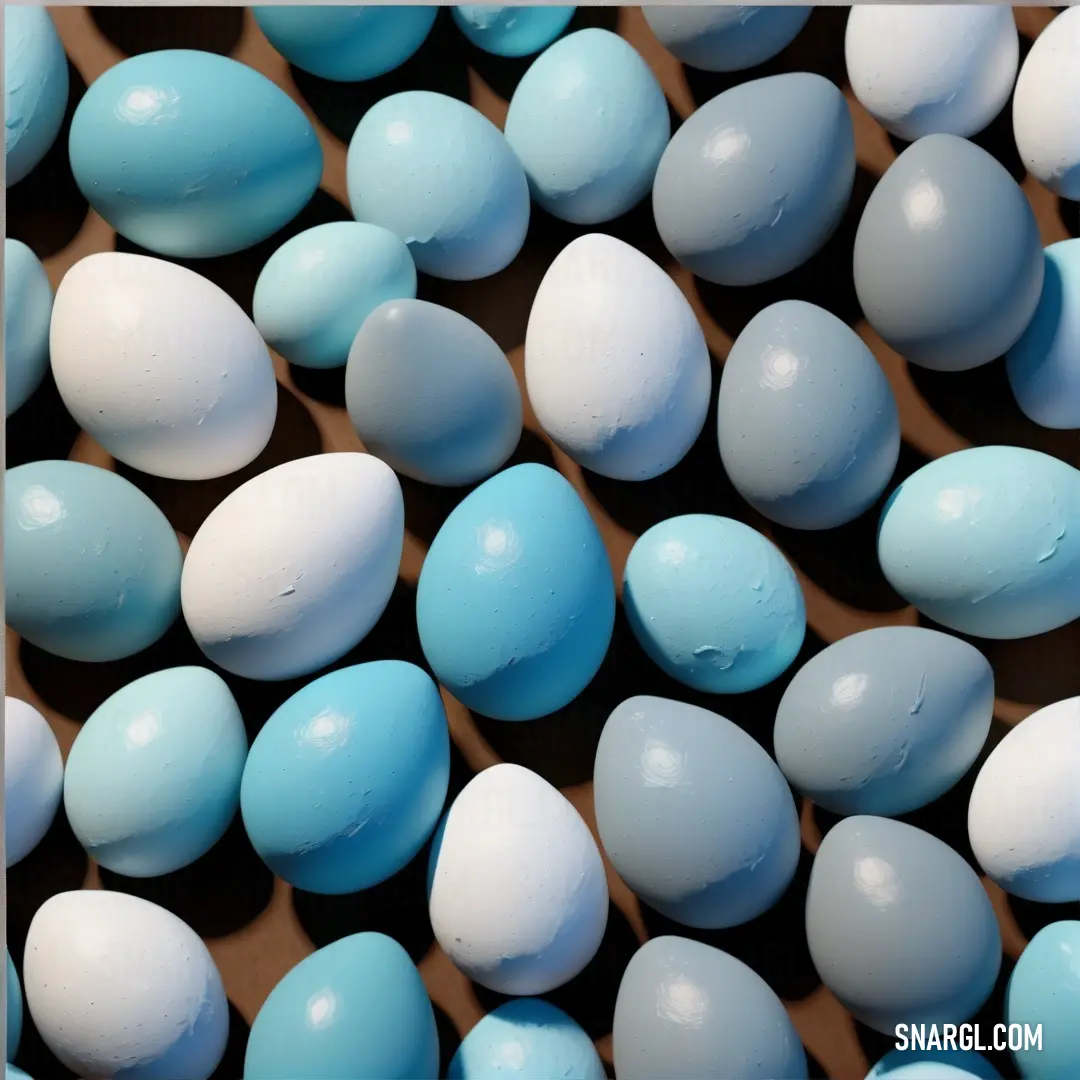 Close up of a bunch of blue and white eggs with water droplets on them and a brown frame. Color RGB 147,204,234.