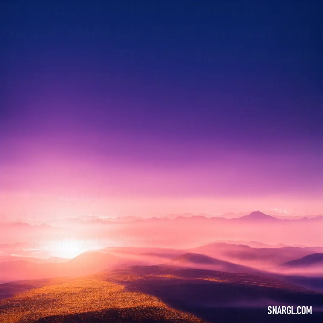 Sunset view of a mountain range with a bright purple sky and clouds in the background with a bright orange sun
