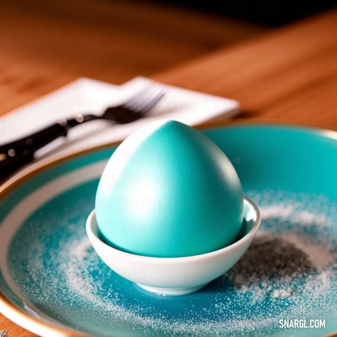 Blue plate with a blue egg on it and a fork and knife on the side of it. Example of RGB 32,178,170 color.