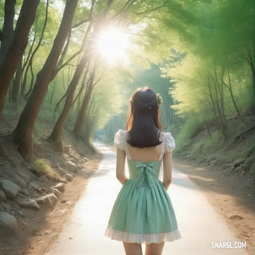 Woman in a dress standing on a road in the woods looking at the sun shining through the trees