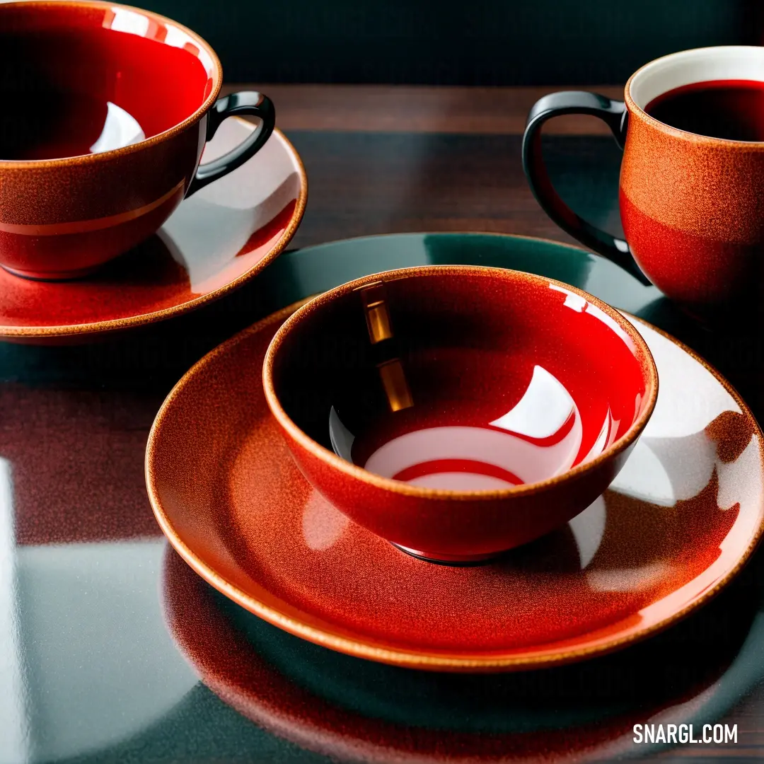 Couple of cups and saucers on a table with a plate and spoons on it and a cup. Color Lust.