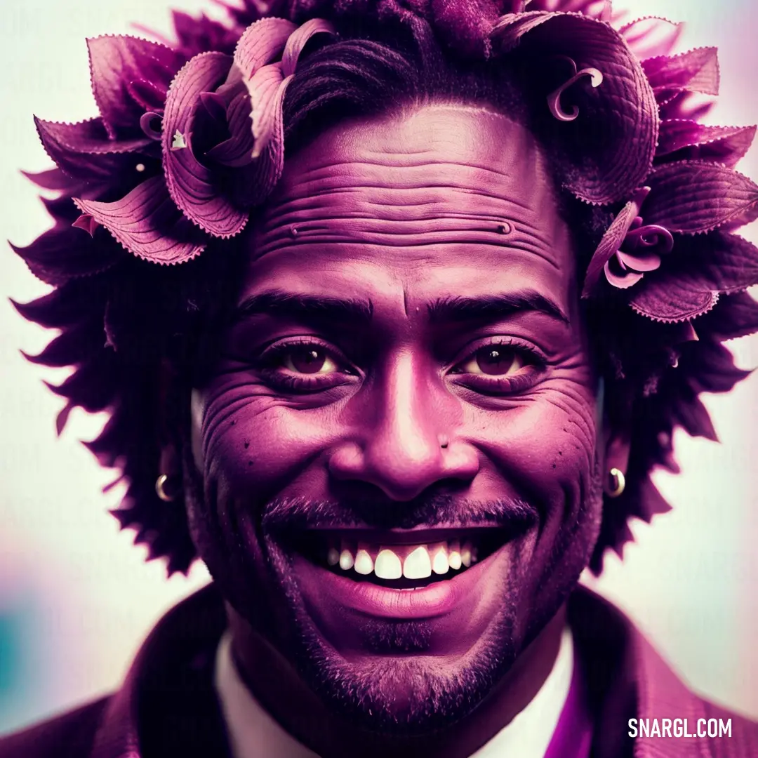 Man with a flower crown on his head smiling for a picture in a suit and tie with a purple background