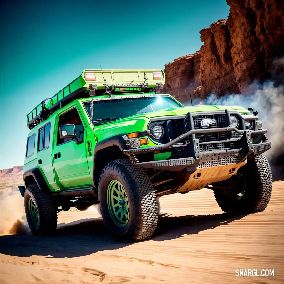 Green truck driving through a desert with rocks in the background