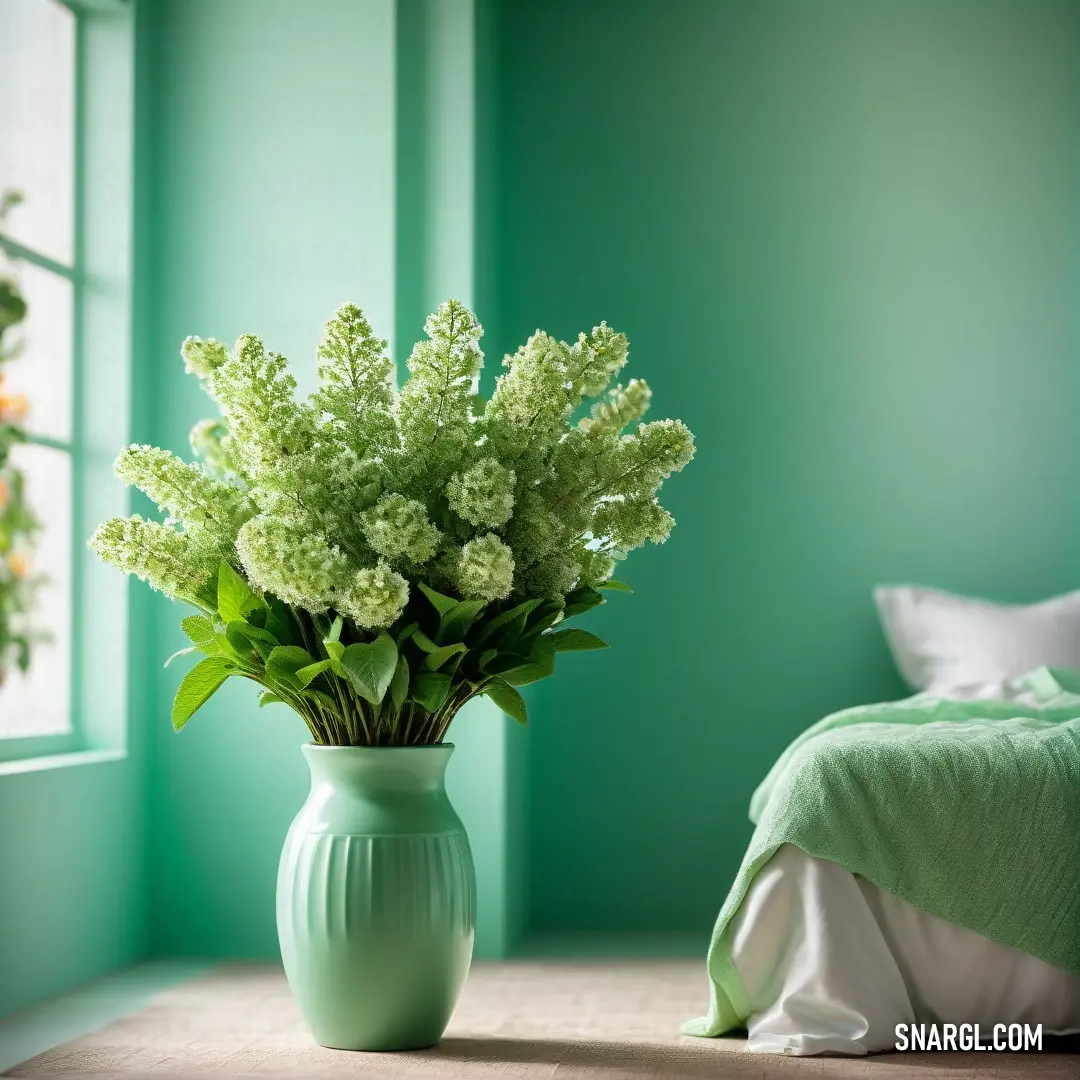 Mantis color example: Vase with flowers in it on a table next to a bed in a room with green walls